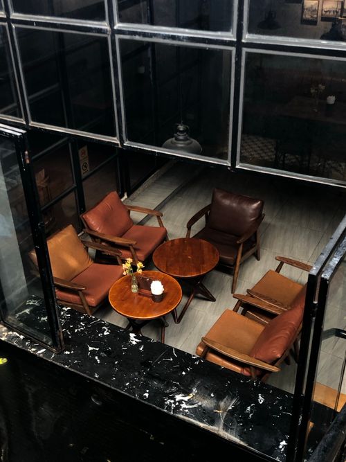 Free Warm and elegant indoor seating area with stylish armchairs and tables. Stock Photo
