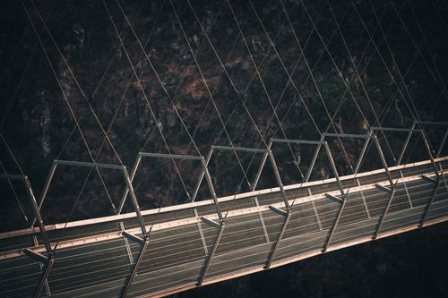 Free Dramatic shot of a modern suspension bridge in Alvarenga, Portugal. Stock Photo