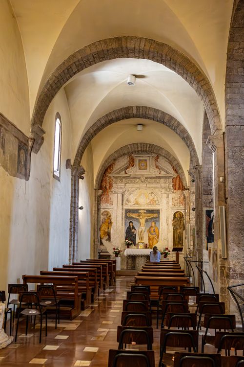 Free Inviting church interior with arches, benches, and ornate altar. Peaceful ambiance. Stock Photo