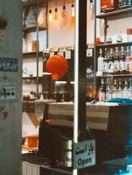 Charming cafe interior with a red balloon, coffee machine, and open sign.