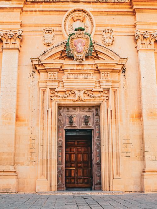 Free Explore a stunning Baroque church entrance with intricate carvings in Malta, showcasing architectural beauty and heritage. Stock Photo