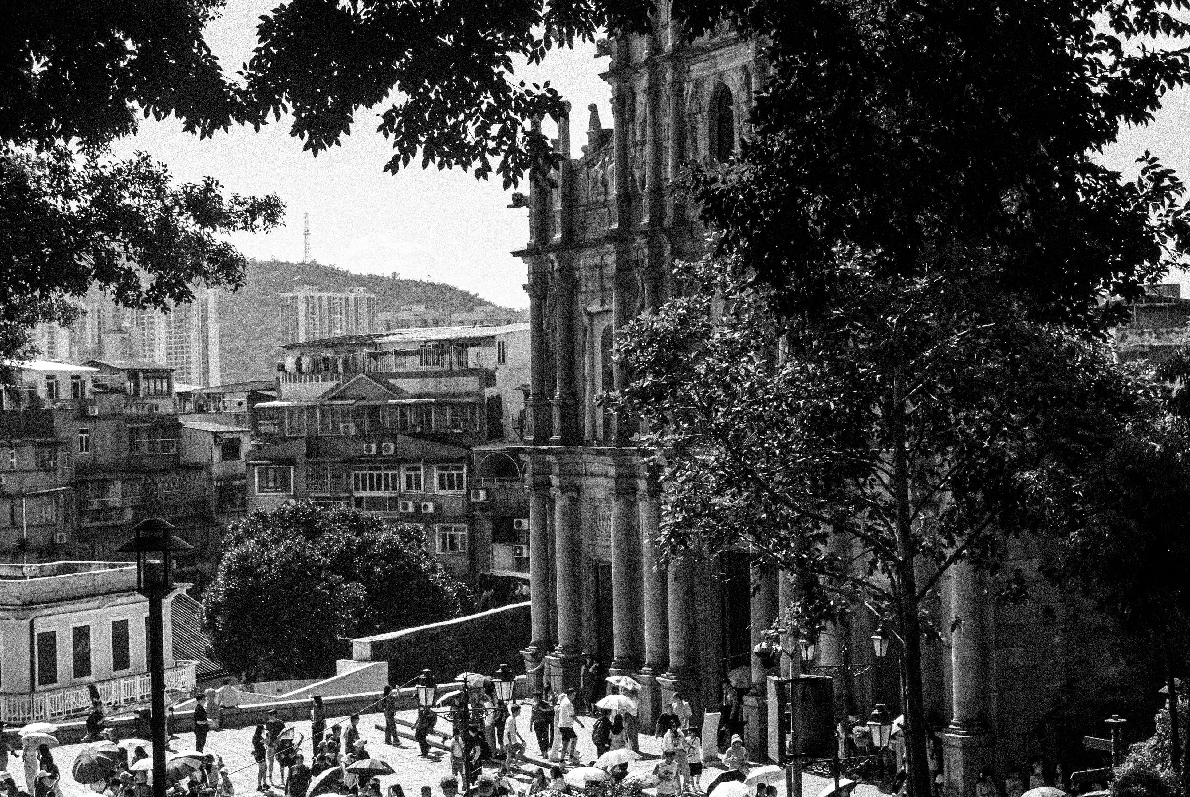 Black and white photograph of the iconic Ruins of St. Paul's in Macau, bustling with tourists.