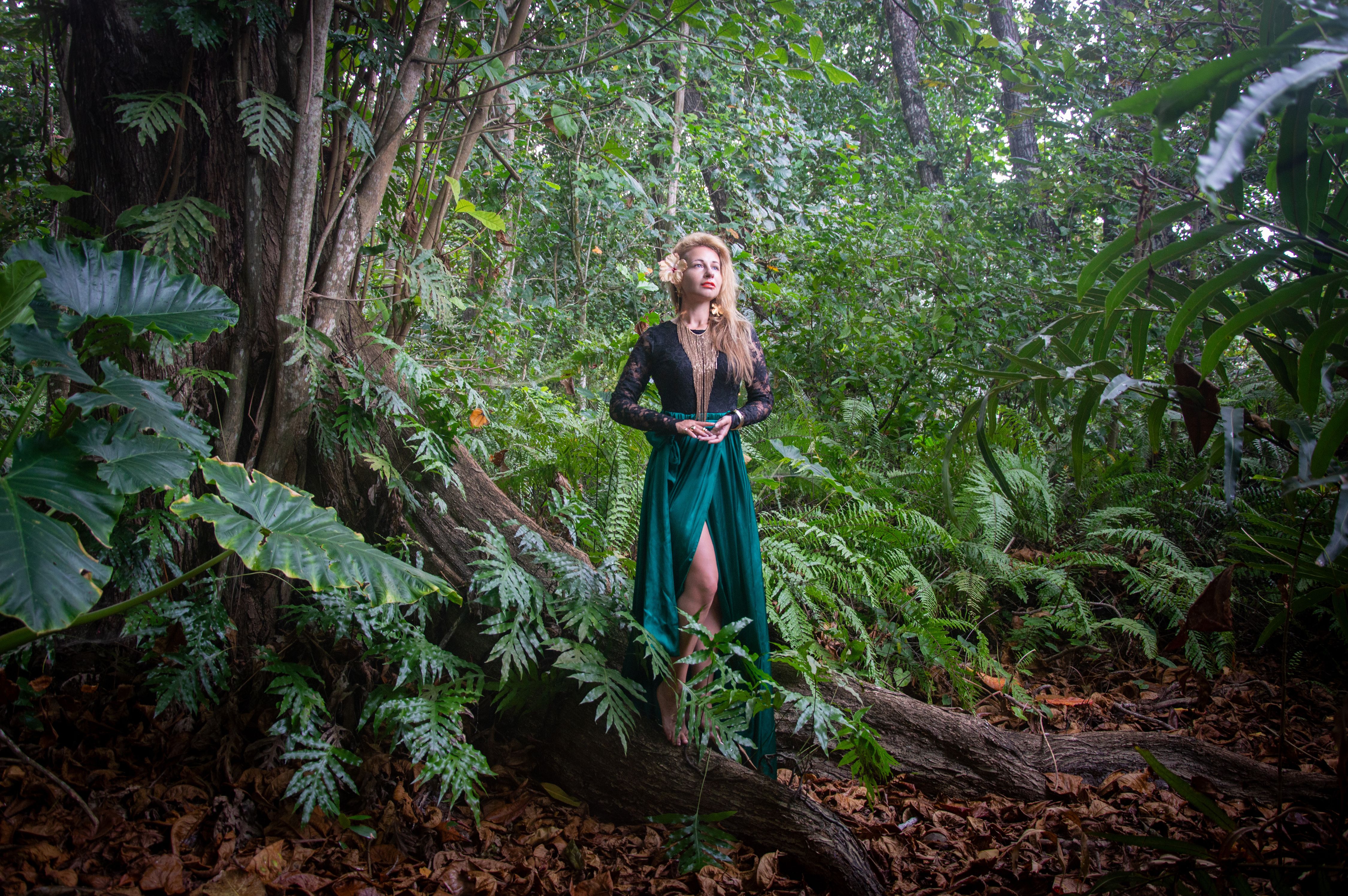Woman in Black Dress Amidst Lush Forest  Free Stock Photo