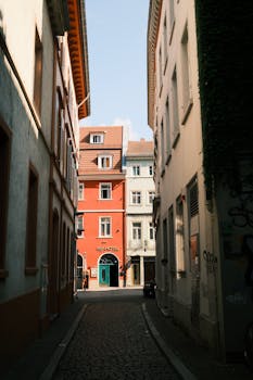 Picturesque alleyway in Heidelberg, Germany with colorful buildings and cobblestone path.