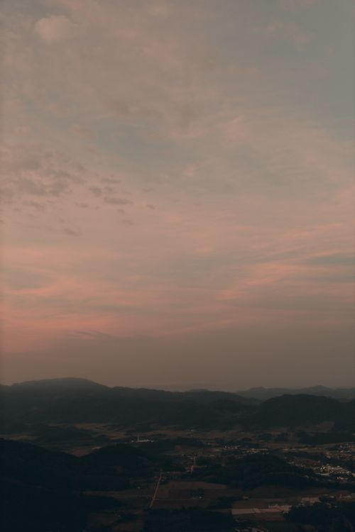 Free Breathtaking aerial view of a tranquil landscape under a dramatic twilight sky. Stock Photo