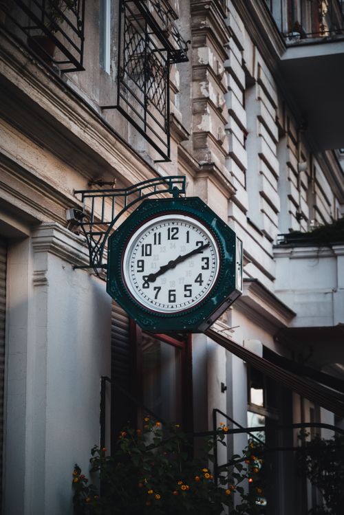 Free A classic vintage wall clock on a Berlin street, showcasing old architectural details. Stock Photo