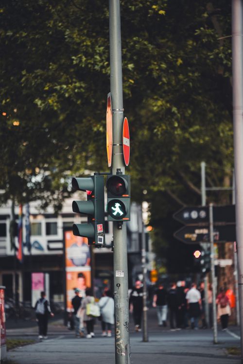 Free Pedestrian traffic light showing green in a busy street scene in Berlin, Germany. Stock Photo