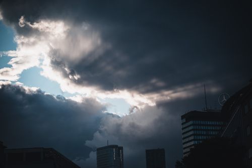 Free A dramatic scene of storm clouds gathering over modern Berlin architecture. Stock Photo