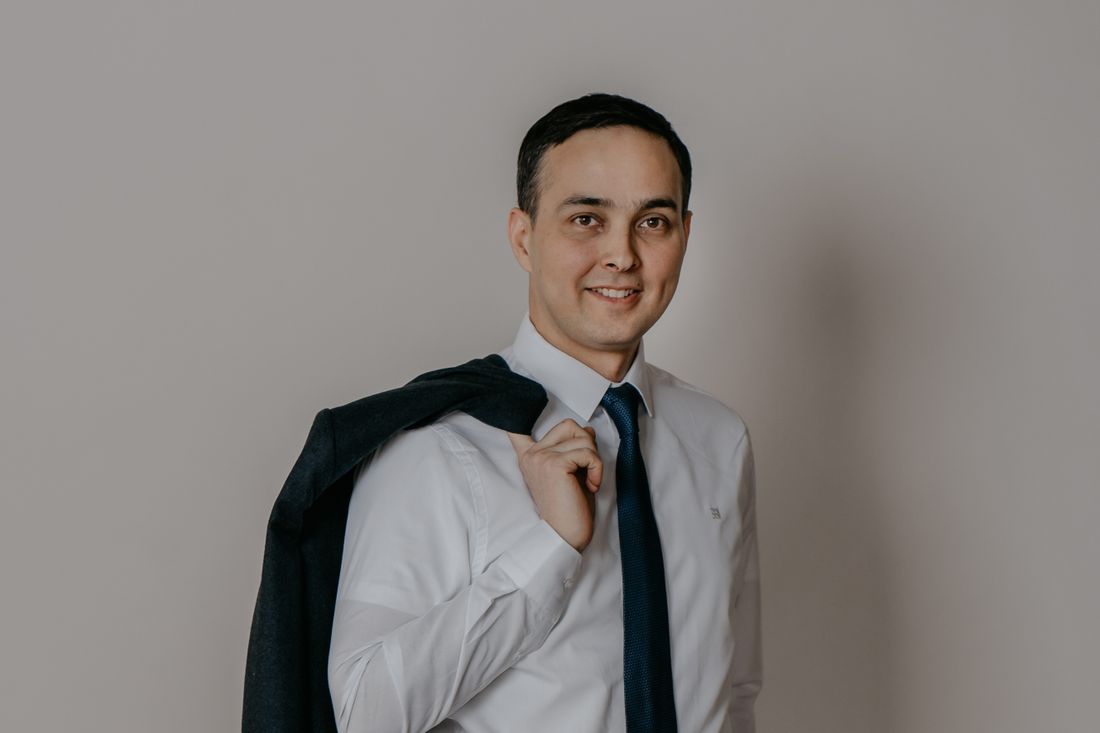 Portrait of a smiling businessman holding his jacket over his shoulder