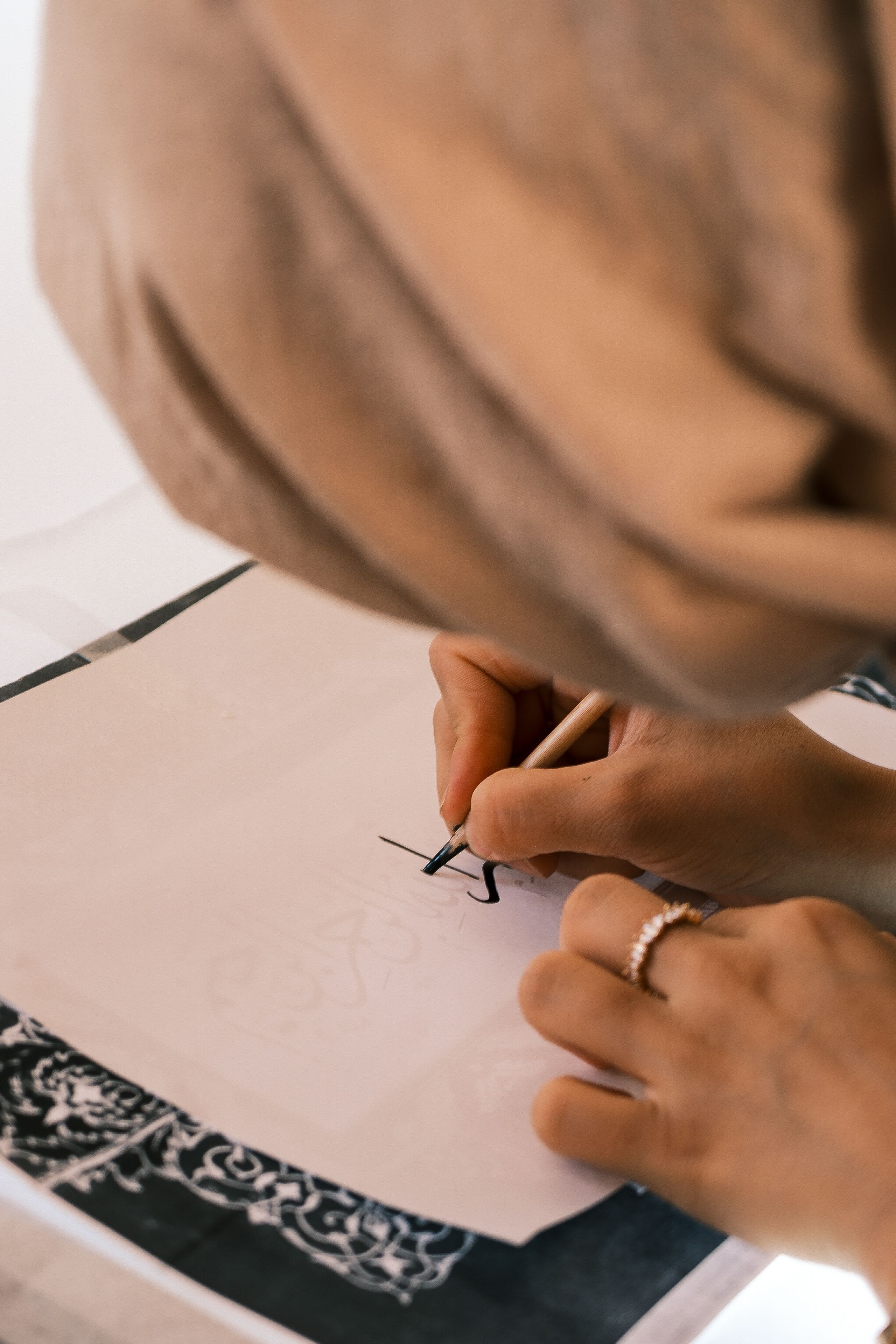 Handwriting Art: Woman Creates Intricate Calligraphy · Free Stock Photo