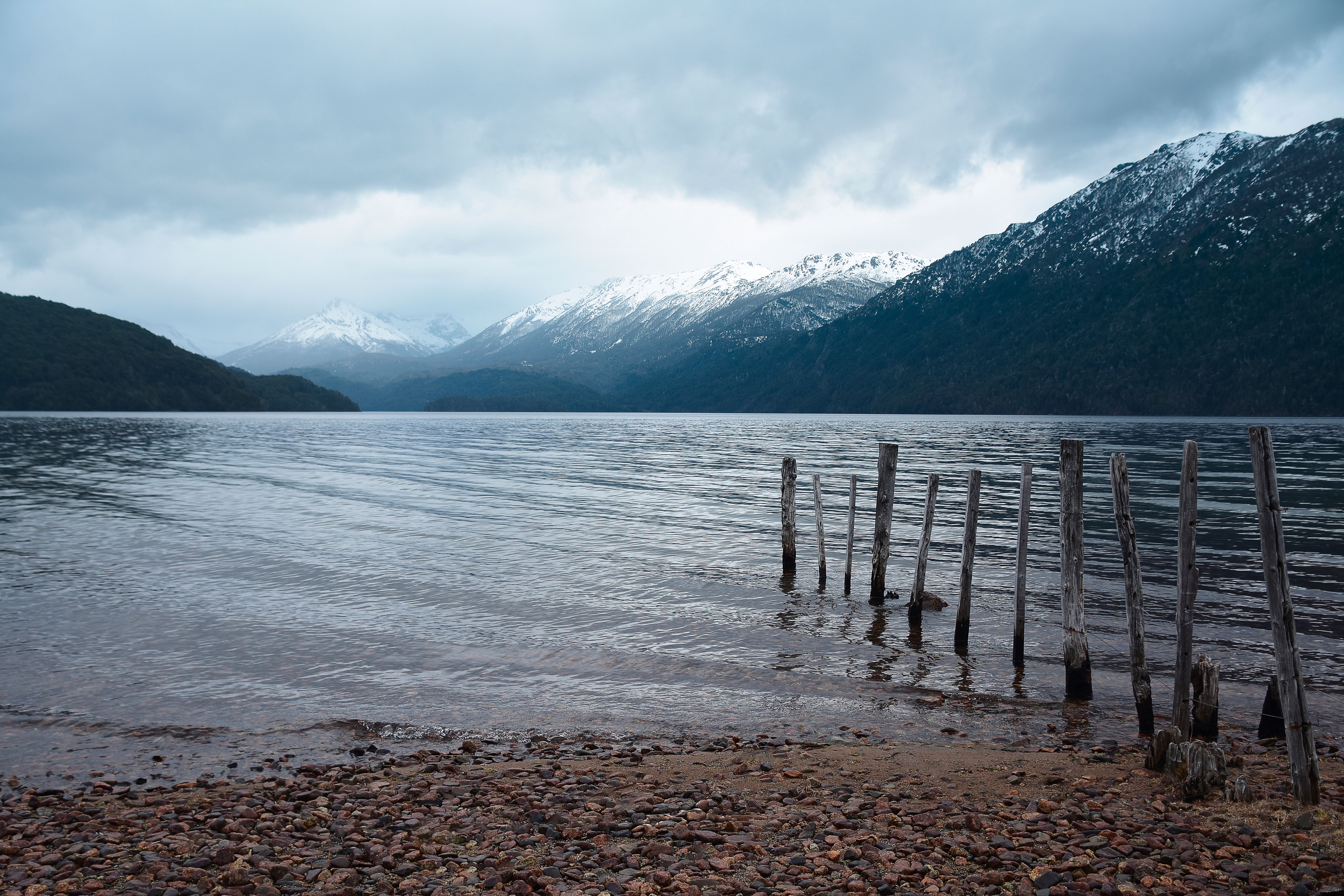 Serene lake and snow-covered mountains in Bariloche, Argentina.