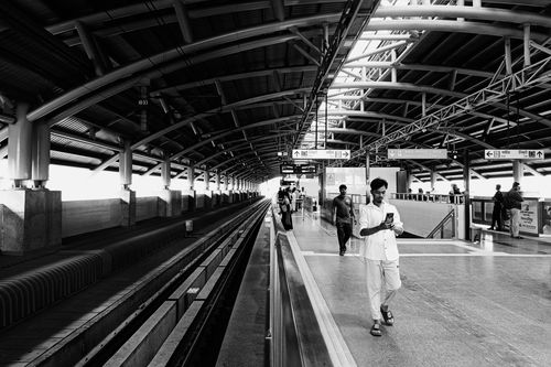 Free Black and white photo of a subway station platform with commuters in motion. Stock Photo