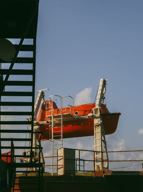 Free Orange lifeboat mounted on a ship in Derepazarı, Rize, Türkiye, with clear sky. Stock Photo