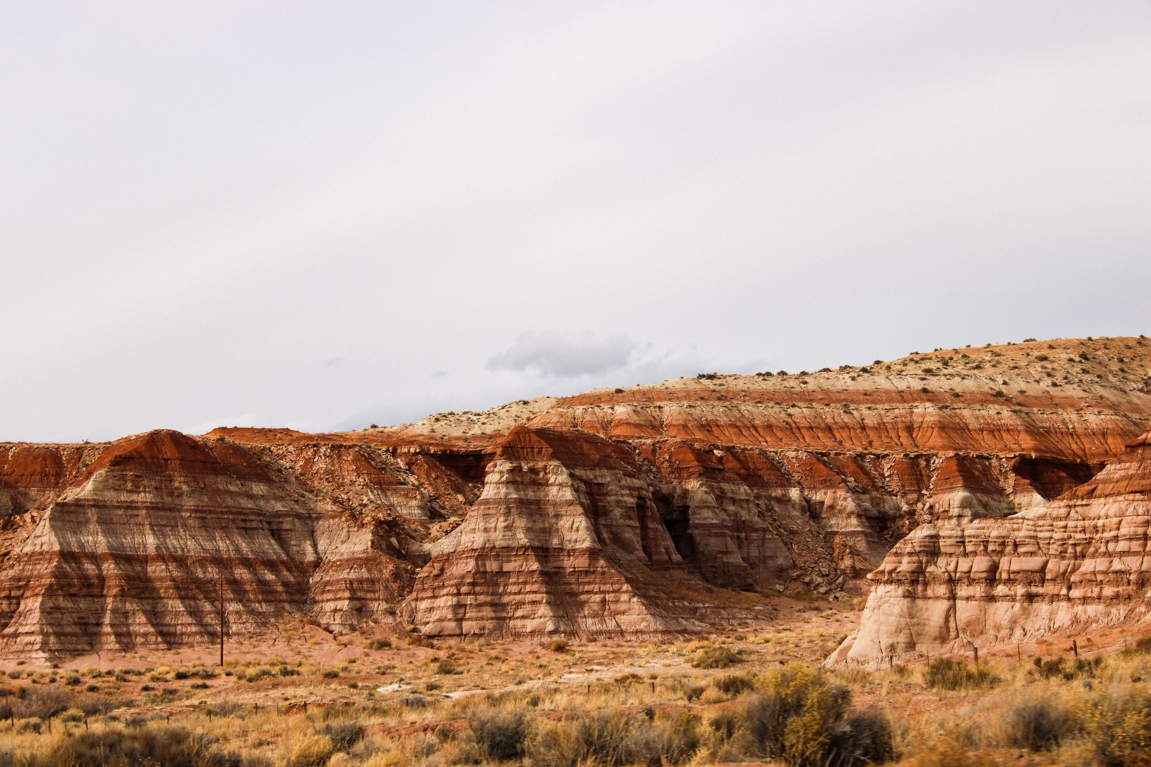 Stunning layered red rock formations in Utah desert landscape under a clear sky.