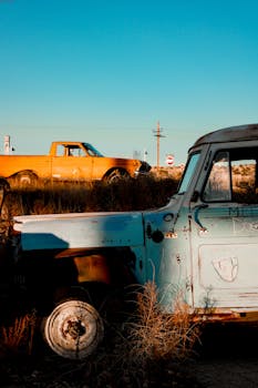 Rusty vintage cars in rural Seligman, Arizona, embodying nostalgia and retro charm at sunset.