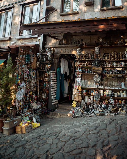 Free Explore a cozy outdoor souvenir shop filled with unique handmade crafts and art pieces, perfect for tourists. Stock Photo
