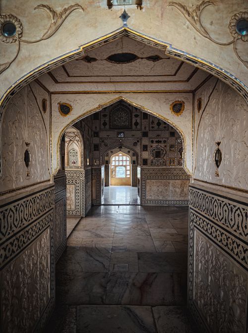 Free Explore the intricate design inside an ornate palace hallway with detailed arches and patterned walls. Stock Photo