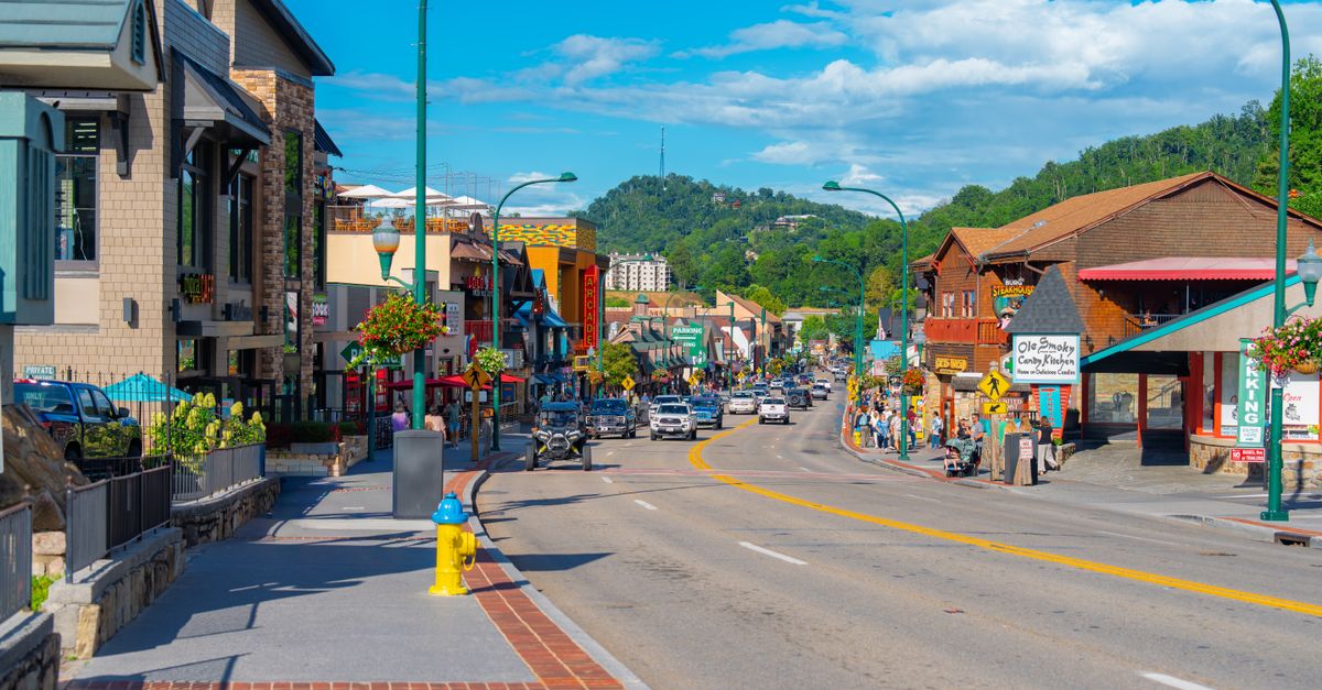 Vibrant street scene on a sunny day in Gatlinburg, showcasing shops and scenic views.