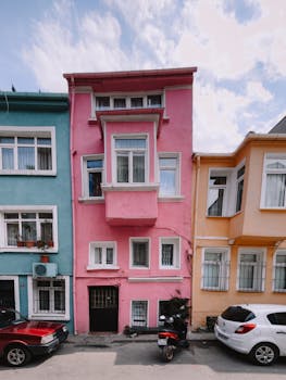 Vibrant pastel-colored facades in an İstanbul street create a lively urban scene.