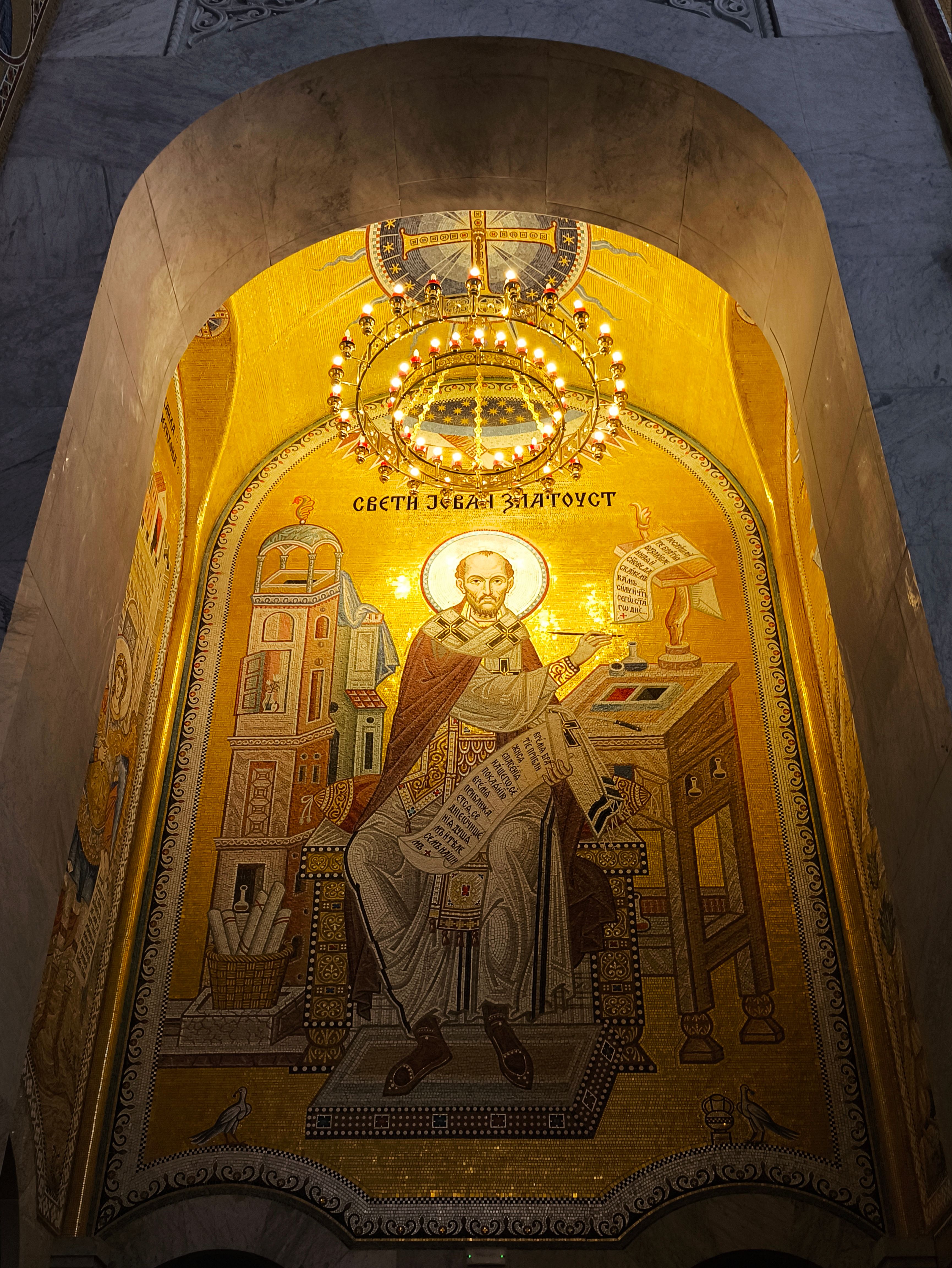 Beautiful illuminated Byzantine mosaic depicting a saint in a church setting.