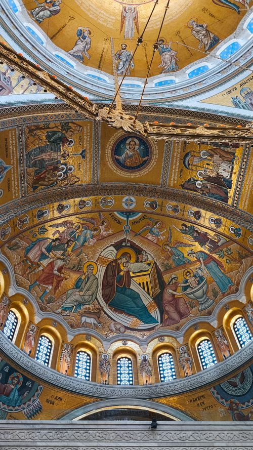 Free Detailed ceiling mosaic depicting religious scenes in a historic dome interior. Stock Photo