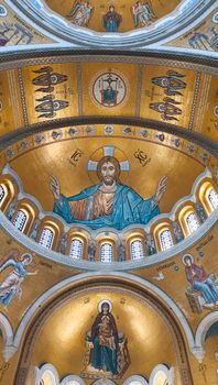 Intricate Byzantine church ceiling showcasing religious iconography and gold mosaics.