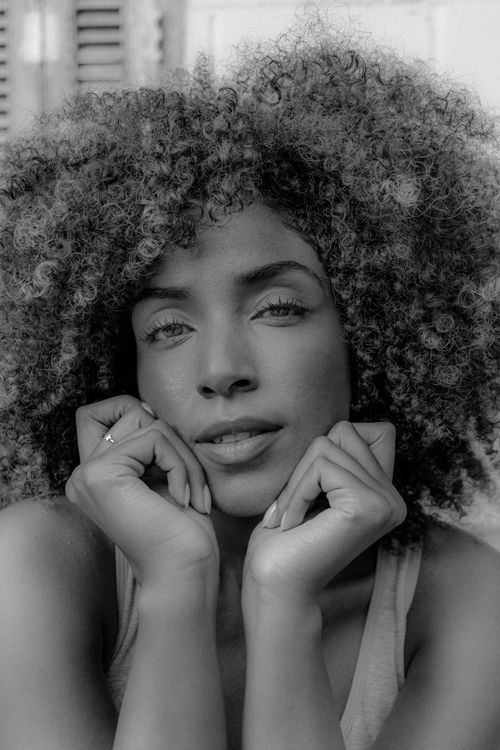Free Black and white portrait of a woman with curly hair, showing natural beauty. Stock Photo