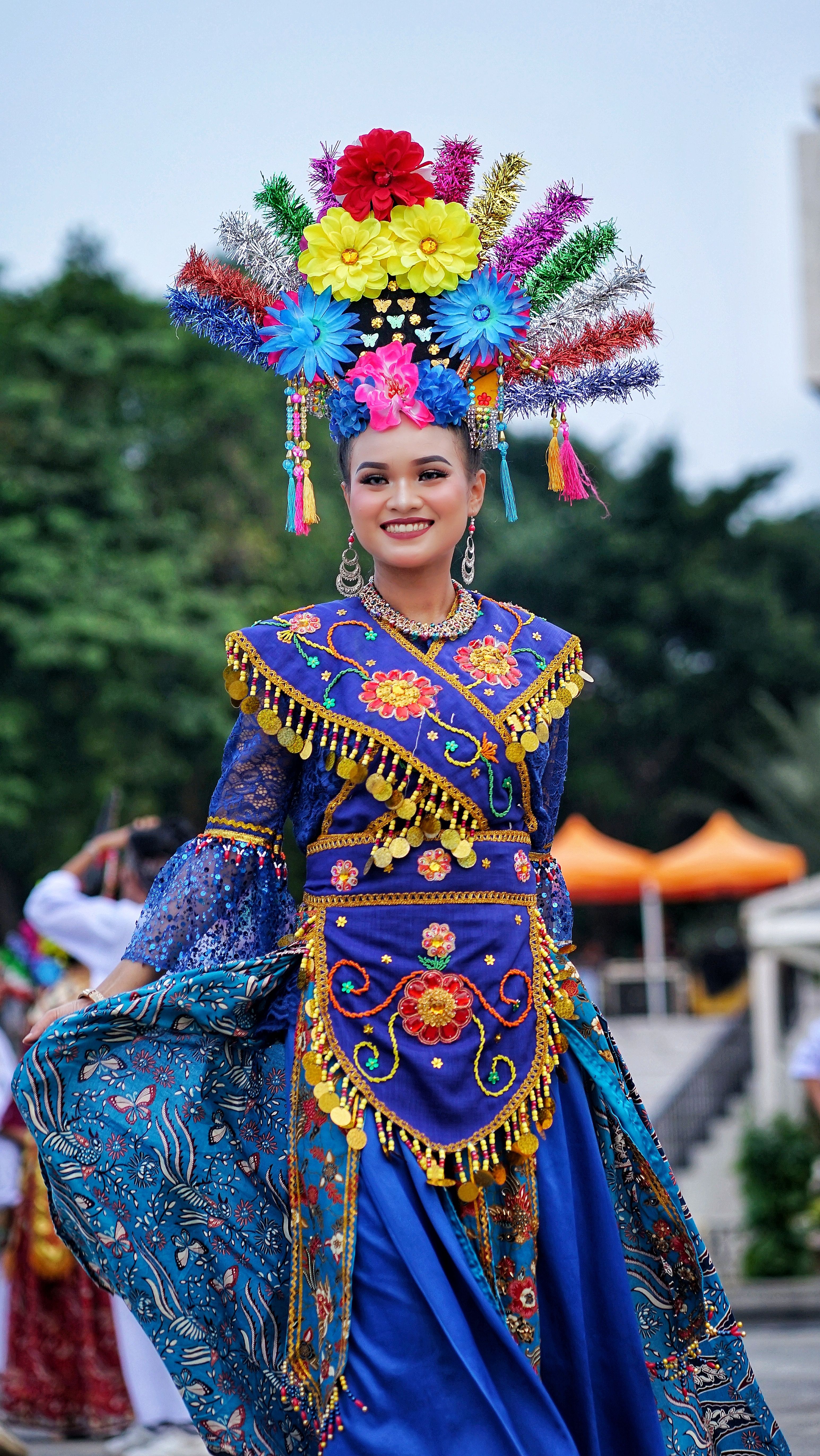 A vibrant display of cultural attire featuring ornate designs and vivid colors during an outdoor festival.