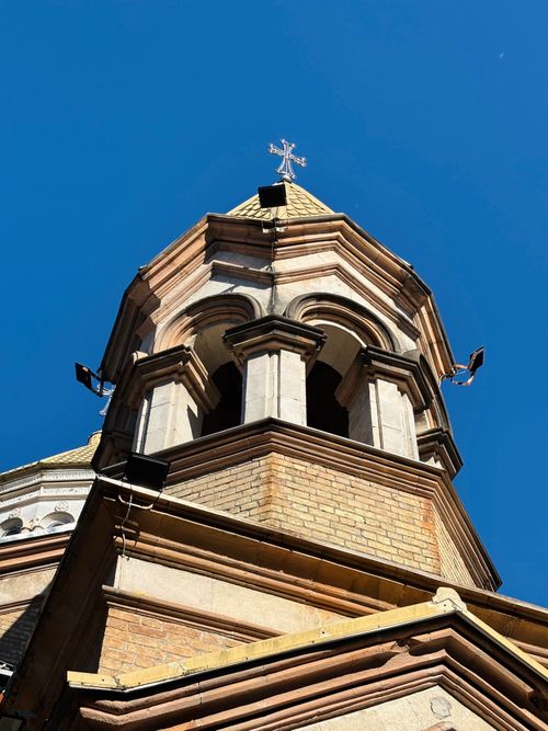 Free Close-up of a historic tower against a vibrant blue sky, highlighting architectural details. Stock Photo