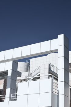 Minimalist white architecture against a clear blue sky in Los Angeles, showcasing modern design.