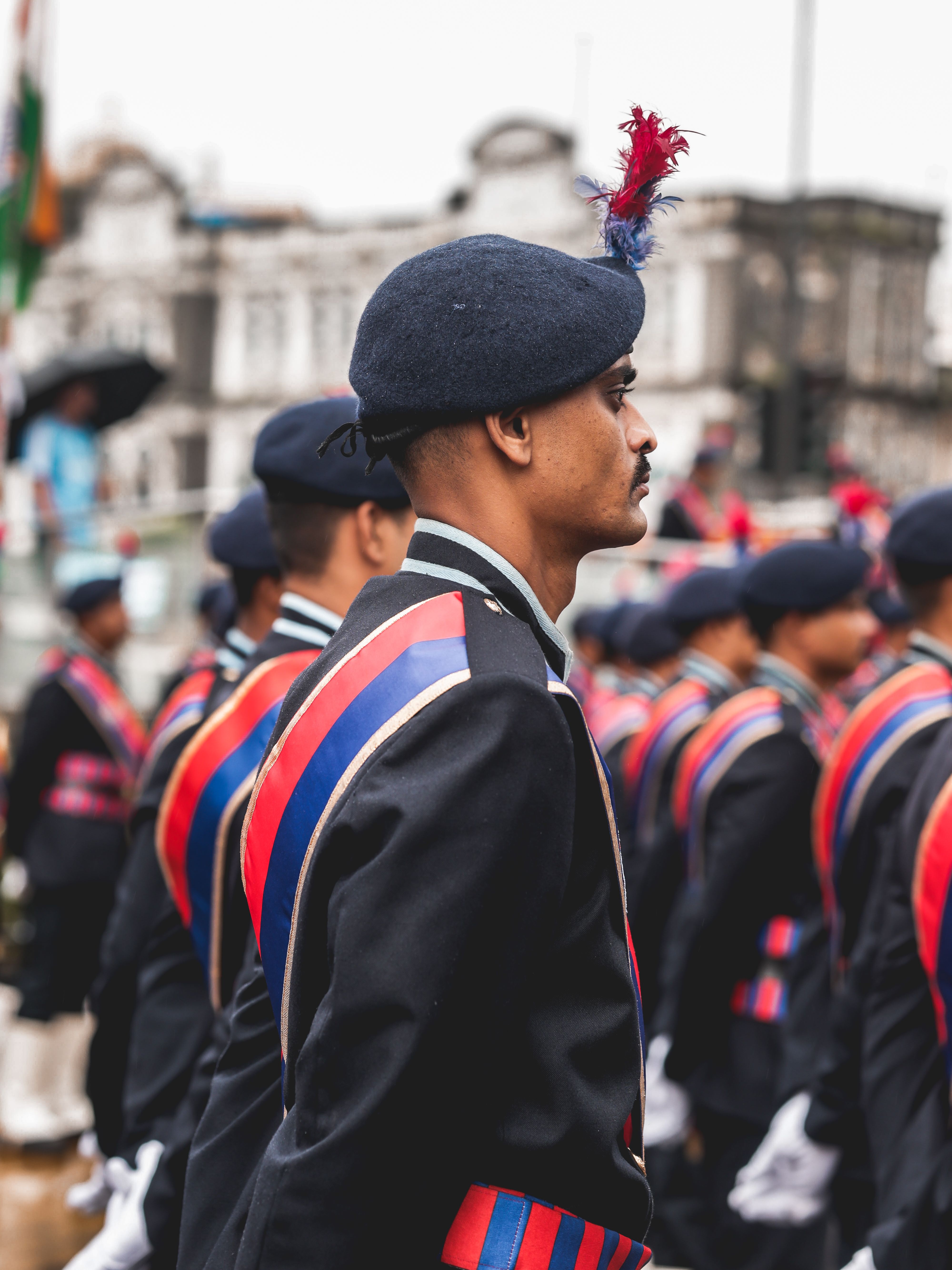 Military personnel in formal uniforms participating in a ceremonial parade, showcasing national pride.