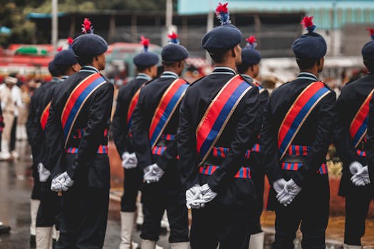 Formal military parade featuring soldiers in traditional uniforms with sashes and berets.