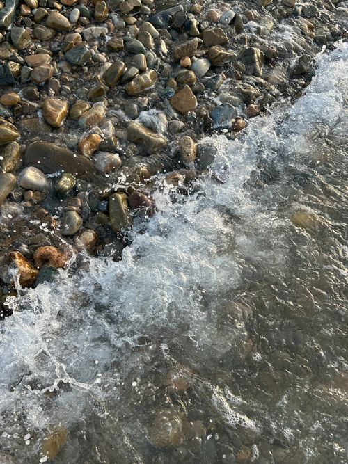 Free A close-up of waves crashing on a pebble beach in Russia, capturing raw coastal beauty. Stock Photo