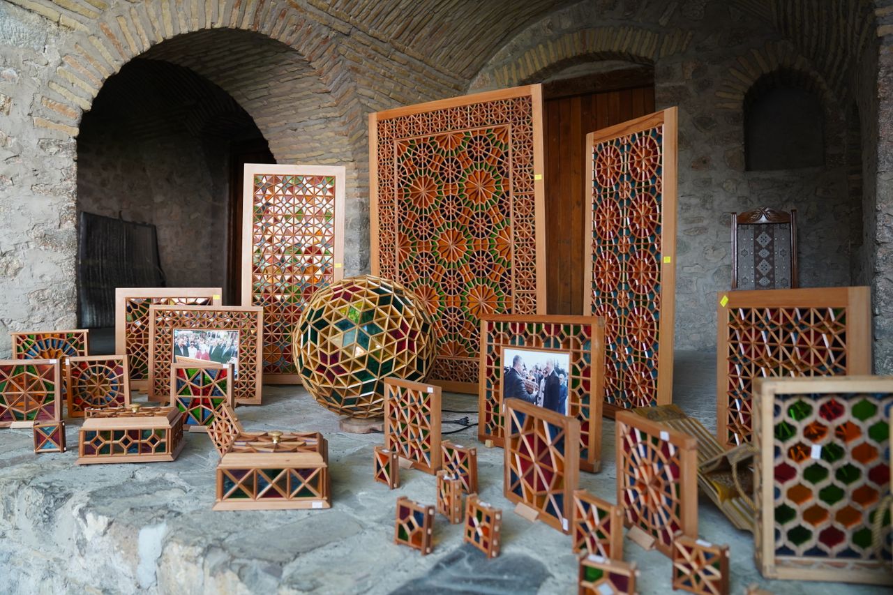 intricately designed wooden crafts with colorful geometric patterns di