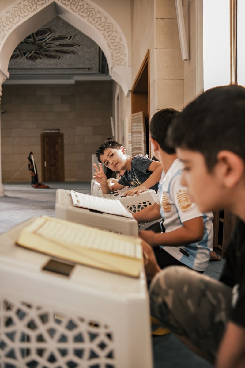 Children engaged in study inside a mosque classroom