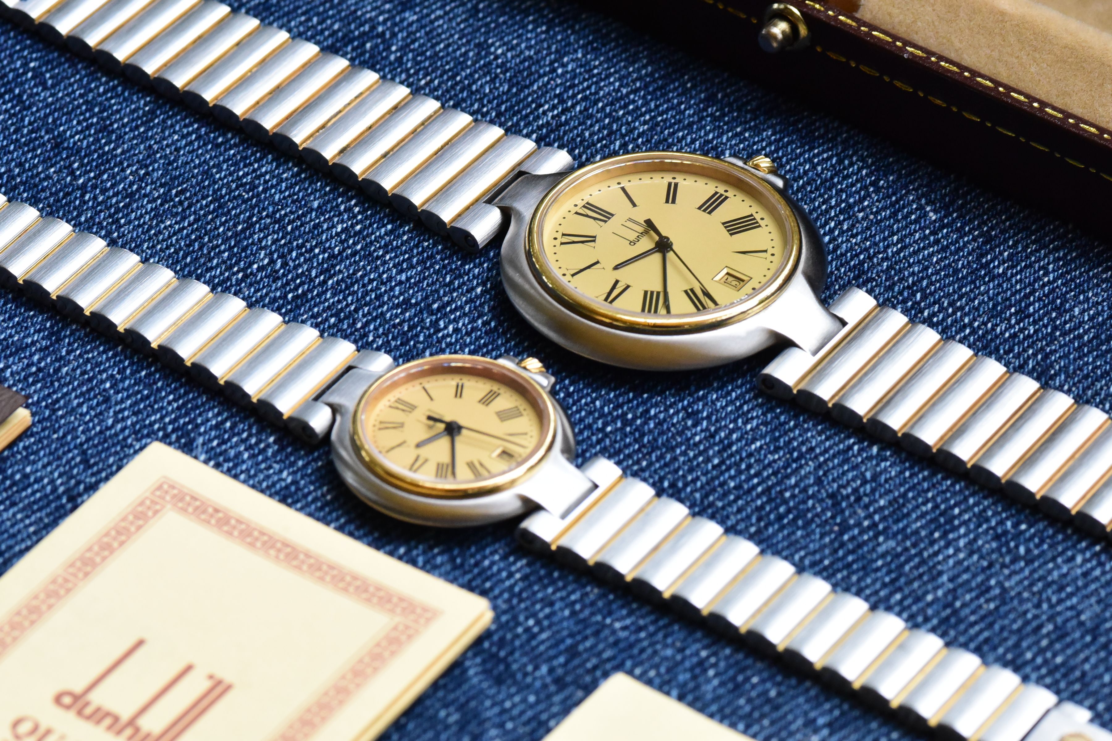 Detail shot of both watch movements visible through exhibition casebacks showing mechanical components