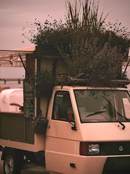 Quaint street truck adorned with flowers on a beach day in Dahme, Germany.