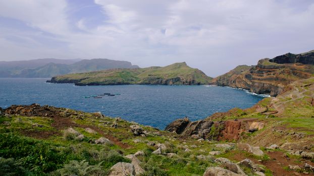 Explore the rugged coastal landscape of Madeira Island in Portugal, featuring cliffs and the Atlantic Ocean.