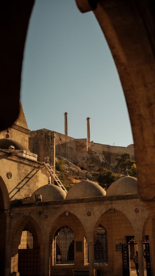 Free Stone courtyard in Şanlıurfa with historical mosque architecture and scenic landscape. Stock Photo