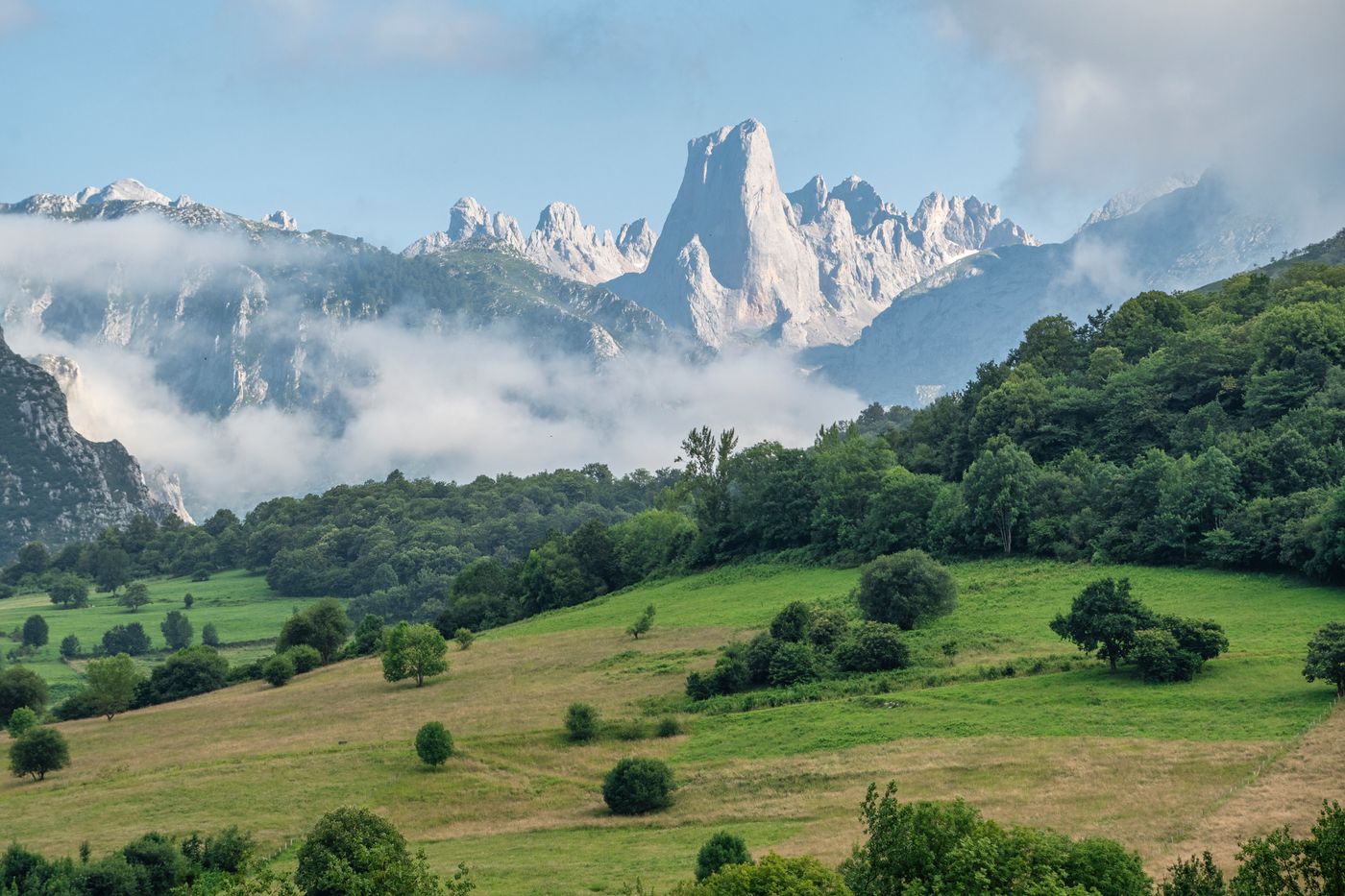 The limestone peaks of the Picos de Europa above green valleys in Asturias, Spain