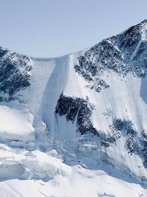 Free A breathtaking view of a snow-covered mountain in Chamonix, France, showcasing icy cliffs and rugged beauty. Stock Photo