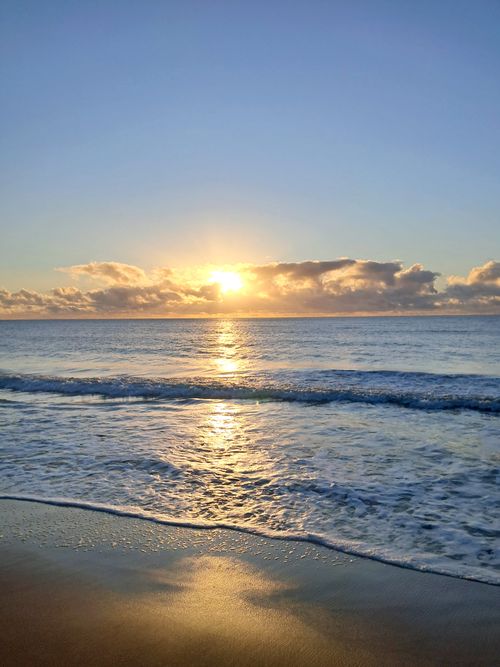 Free Stunning sunrise at João Pessoa beach, capturing the serene Atlantic waves and vibrant sky. Stock Photo