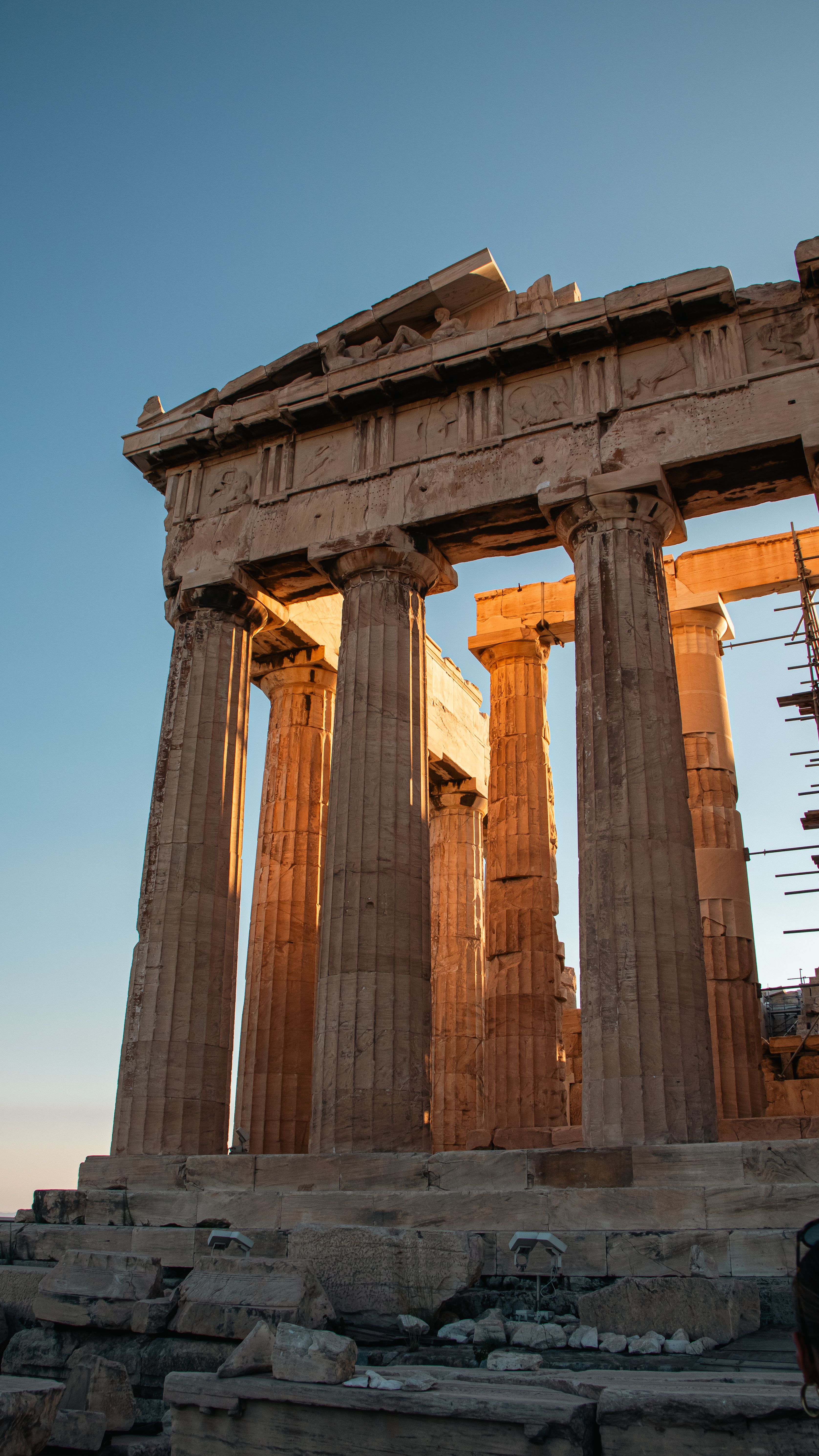 View of the iconic Parthenon in Athens, Greece, illuminated by the sunrise.