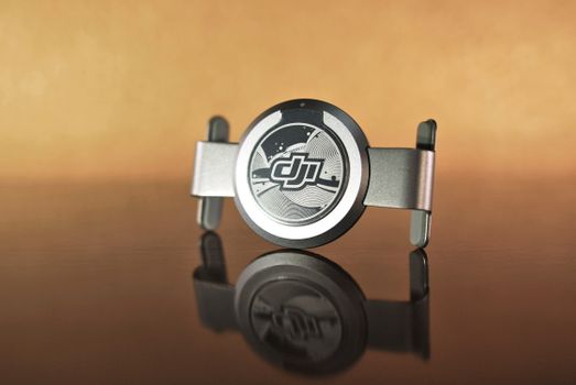Elegant metal design object with a clean reflection on a glossy surface, showcasing modern artistic style.