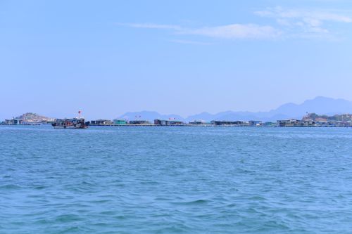 Free Idyllic view of fishing village with mountains in Ninh Thuận, Vietnam on a sunny day. Stock Photo