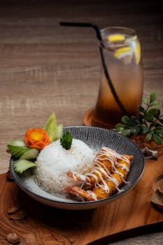 Delicious Japanese tempura shrimp with rice and garnish served in a bowl, perfect for food photography.