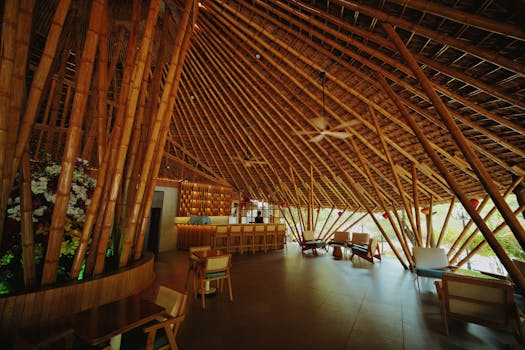 Spacious bamboo restaurant interior with natural lighting and modern decor.