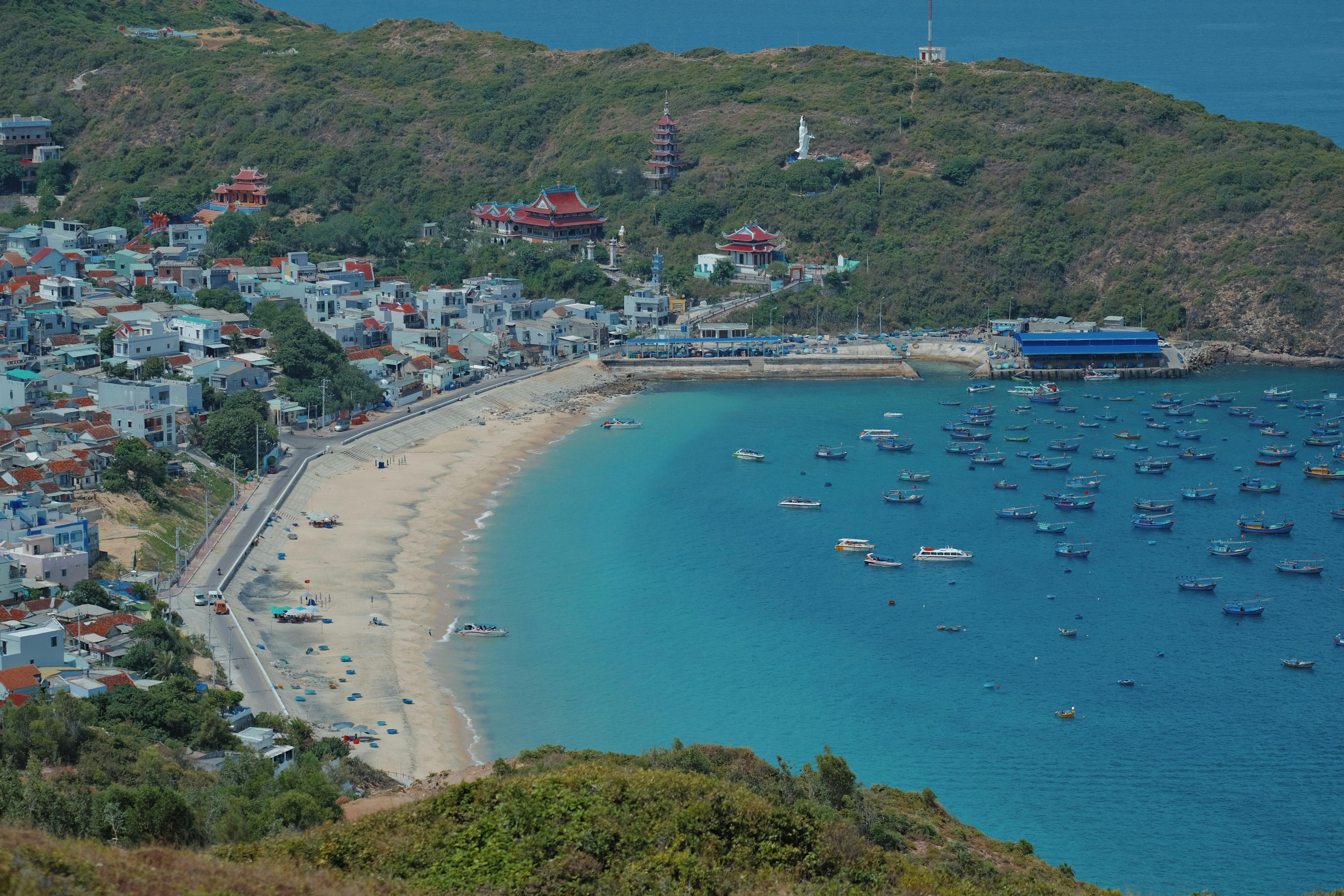Aerial view of Quy Nhon beachfront with clear blue waters and sandy beach.
