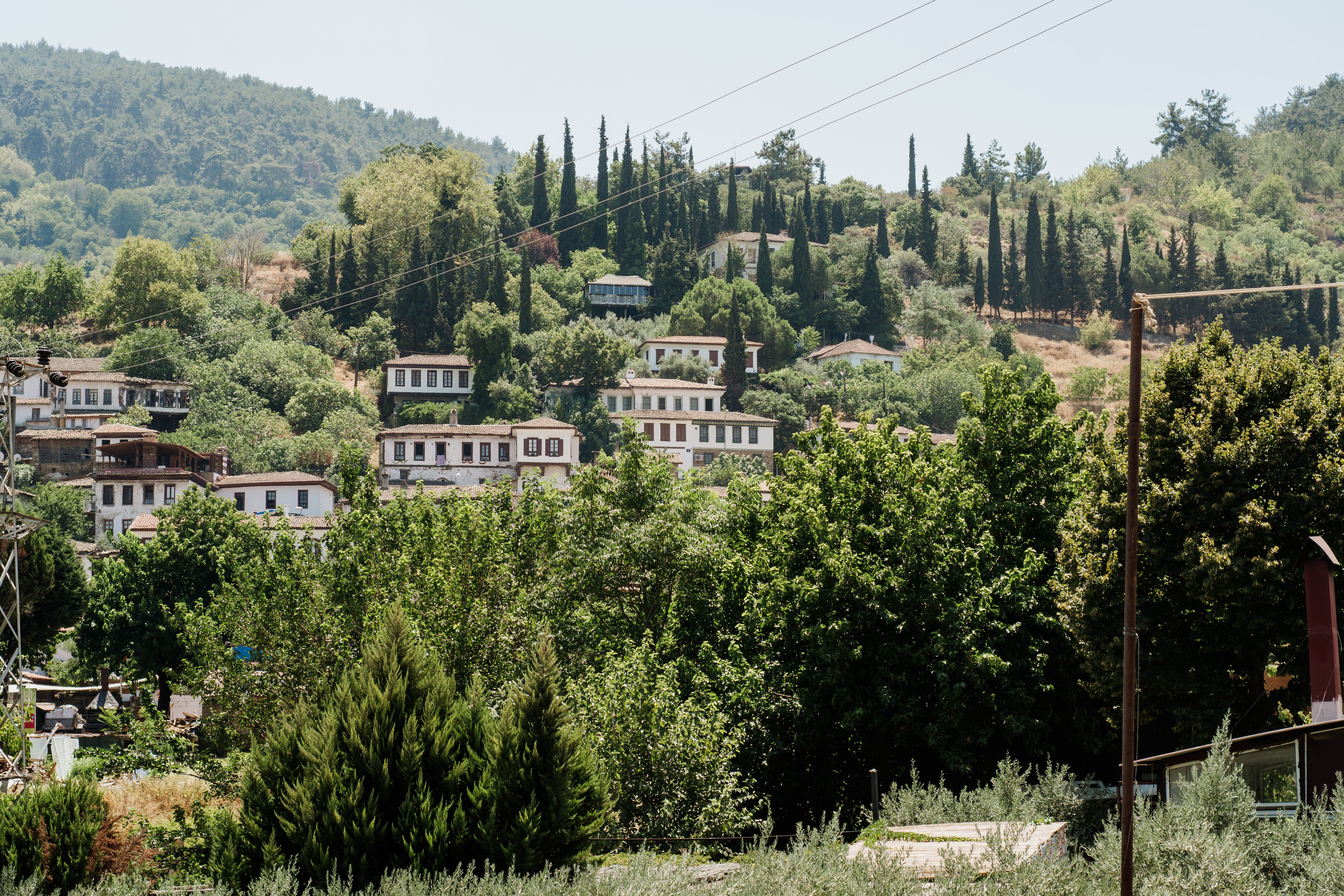 Terraced stone houses and vineyards of Şirince village at golden hour, İzmir, Turkey, Aegean hills with wine tasting terraces