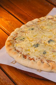 Mouthwatering cheese pizza served on a wooden table, perfect for food lovers.